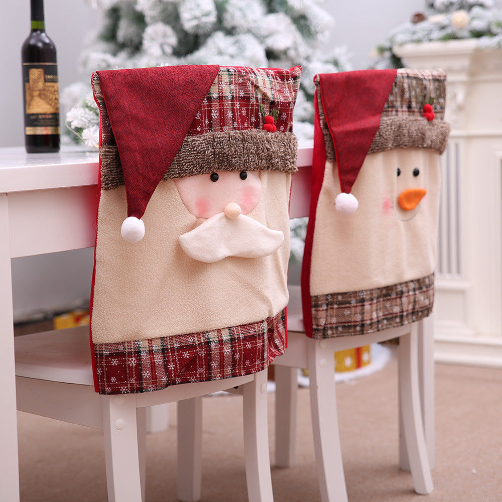 Festive Santa and Snowman chair covers with plaid trim and plush details for holiday dining.