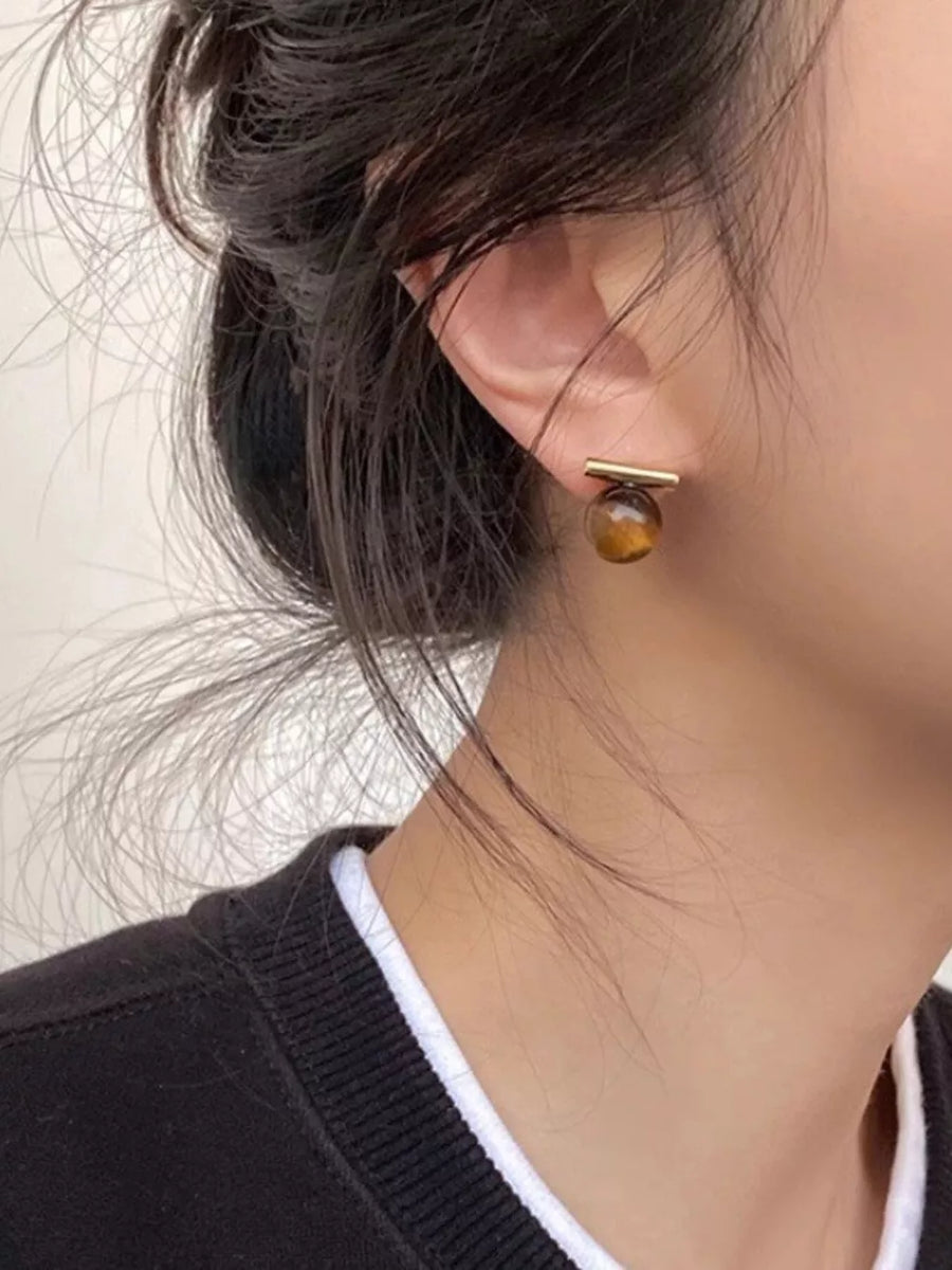 ACCESSORIES in gold with natural stone pattern and stud