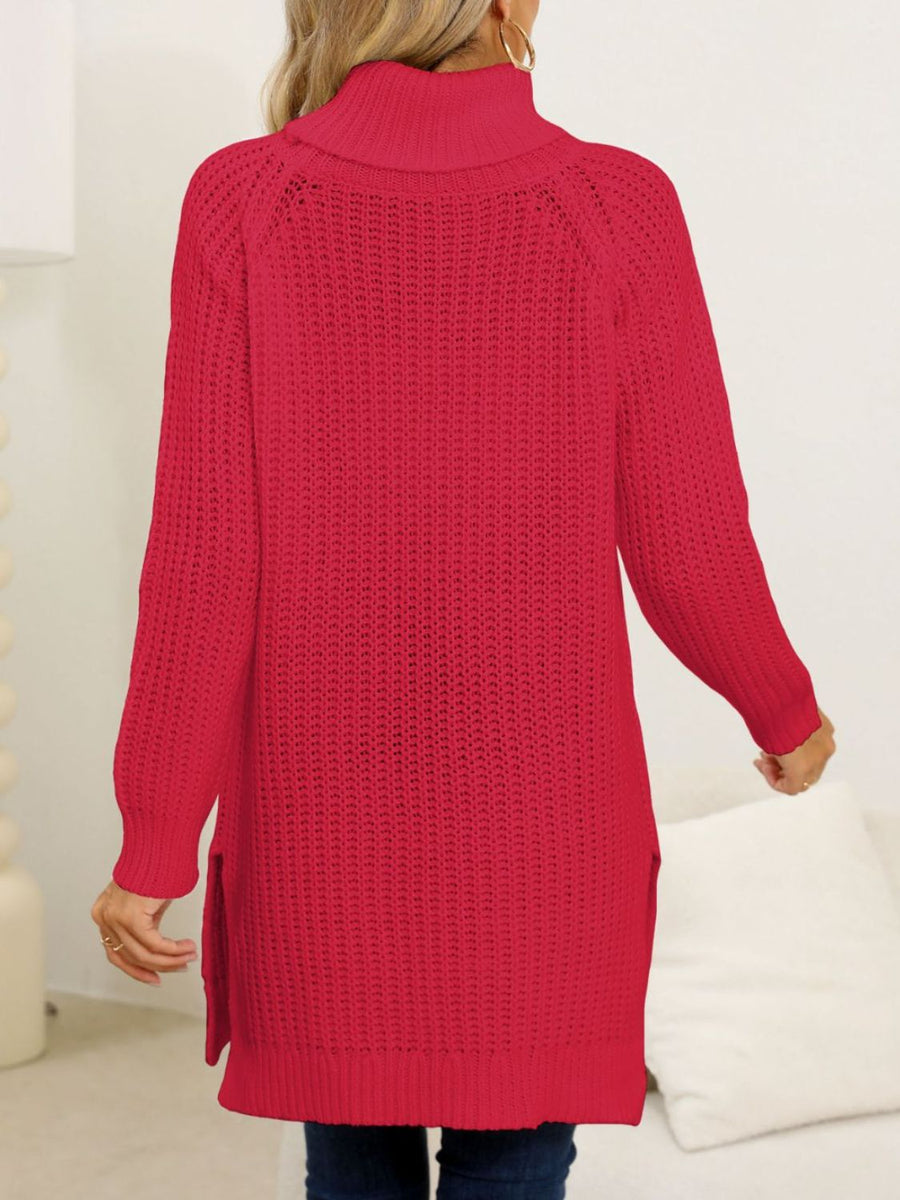 Scarlet knit turtleneck sweater with asymmetric hem and side slits.