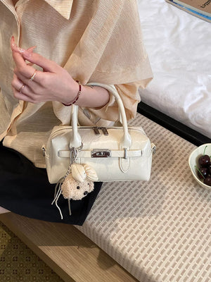 handbag in cream featuring top handle and boxy fit