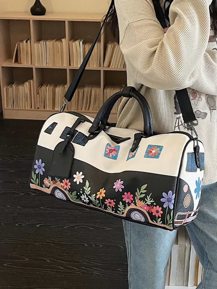 Flower Power duffel bag in black and white with colorful floral camper van print
