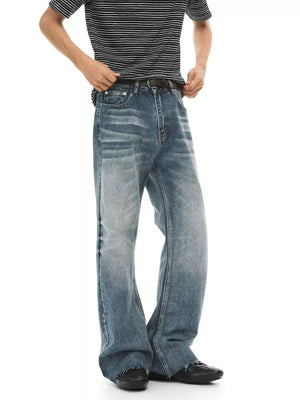 Men's blue wash denim flare jeans with whiskering and fading.