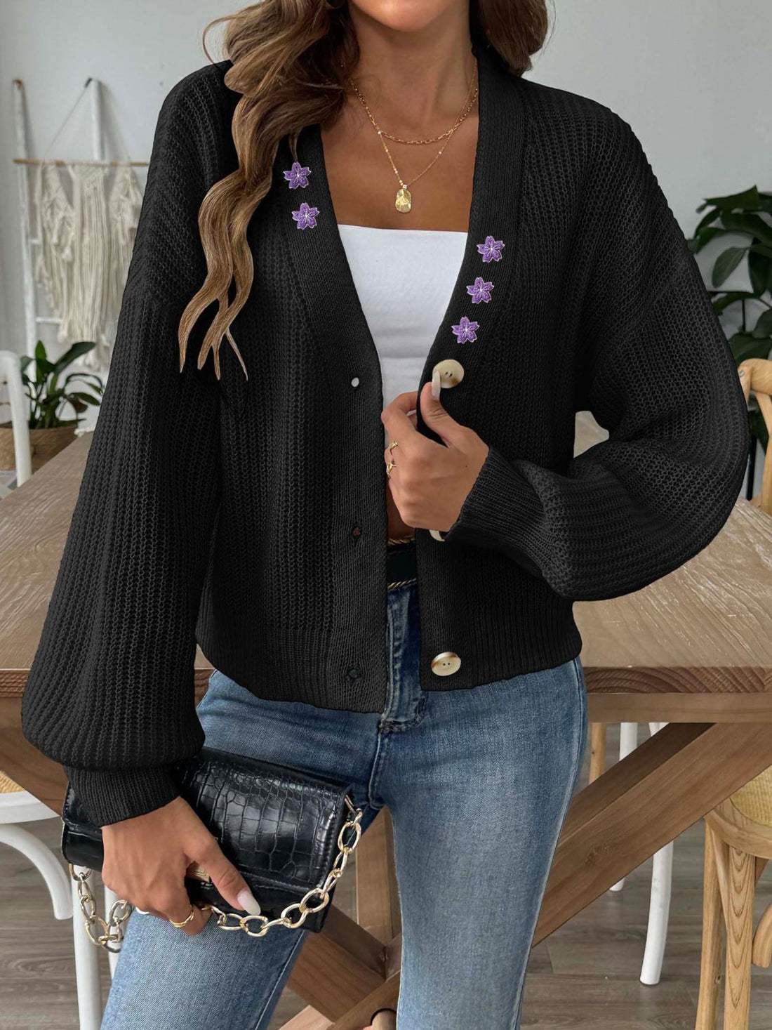 Black balloon sleeve cardigan with floral embellishments and button front.