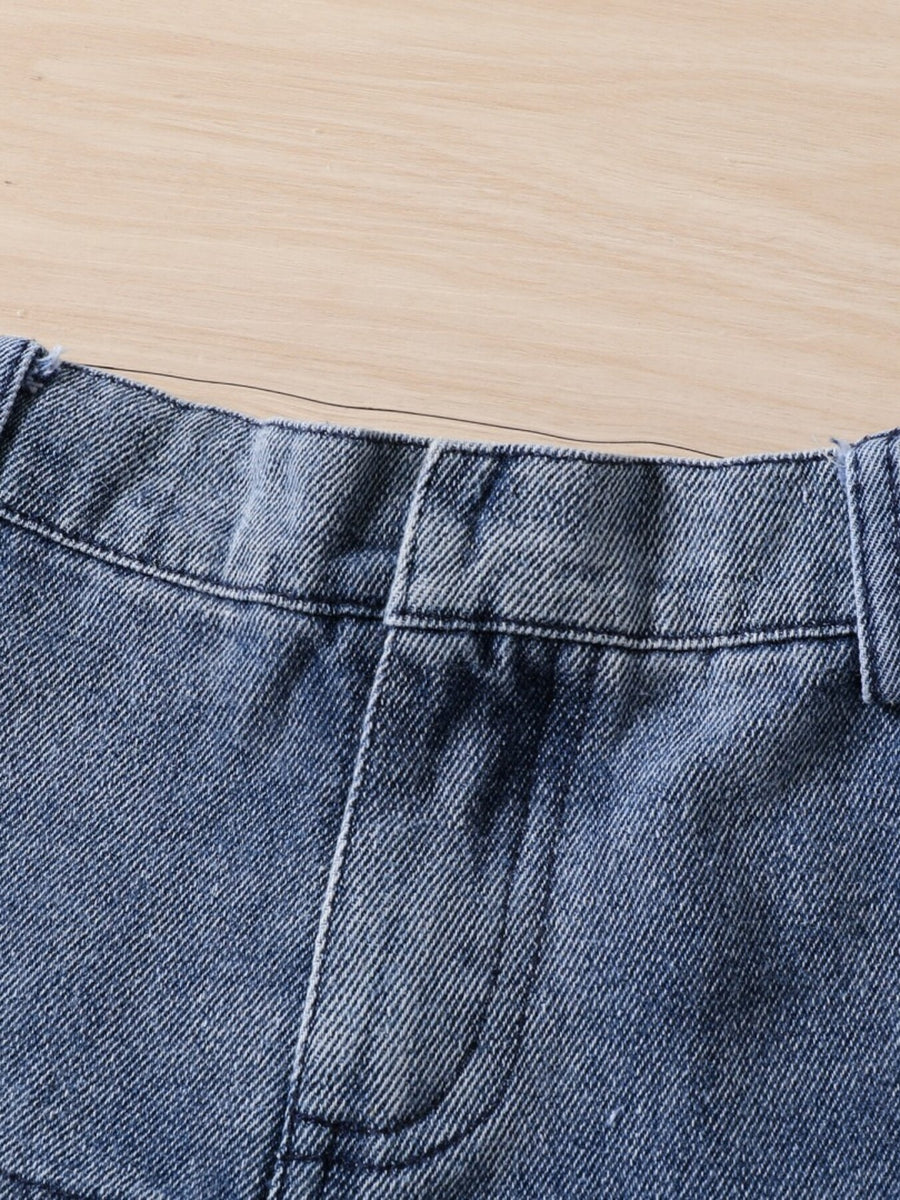 Toddler denim shorts with elastic waistband and pocket detail.