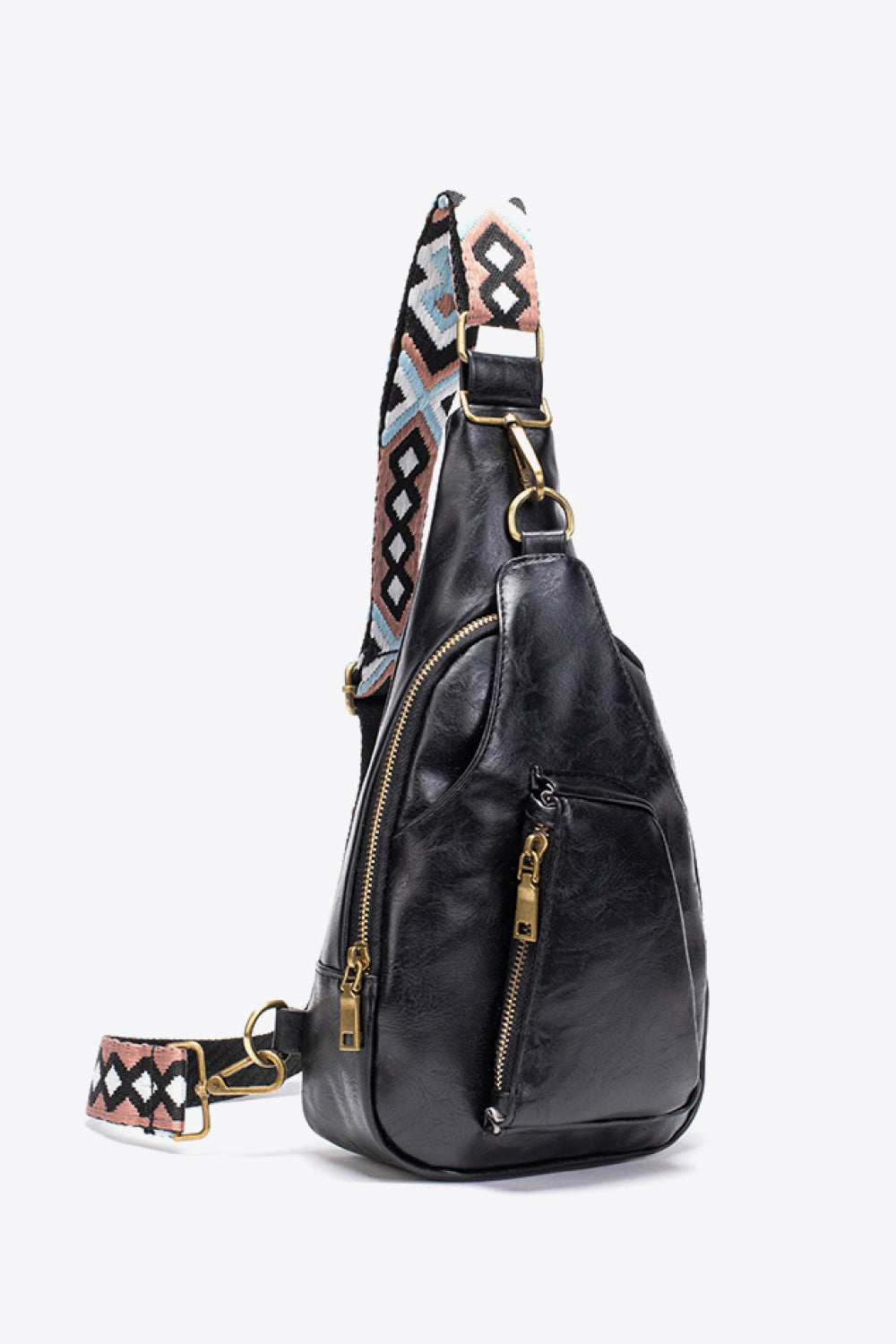 Black textured sling bag with woven geometric strap detail and gold zippers
