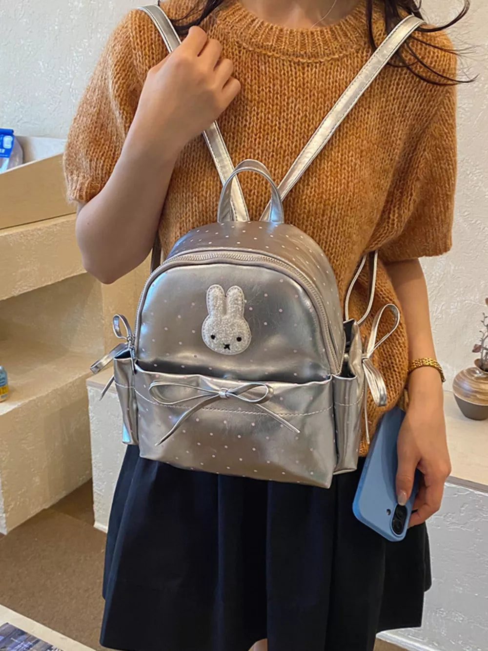 backpack in silver featuring bunny appliqué and boxy fit