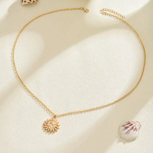 Gold sunburst pendant necklace with a delicate chain, bohemian style.