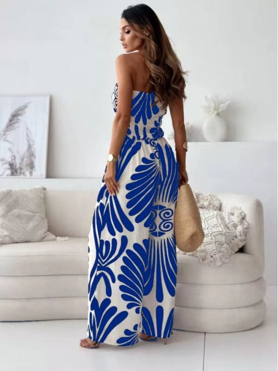 Strapless wide-leg romper in white with blue tribal print, smocked bodice, and wide legs.
