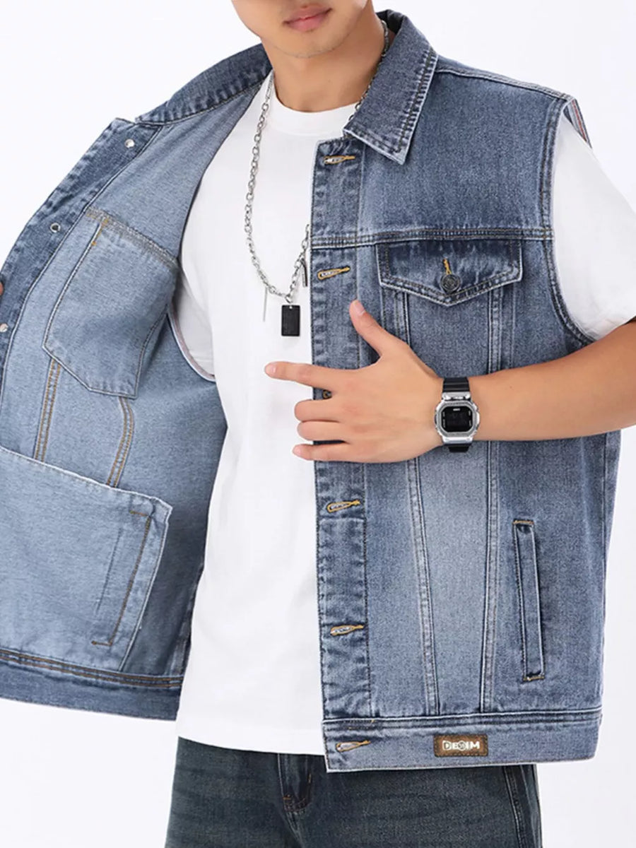 Light wash denim vest for men with button front, chest pockets and side pockets.