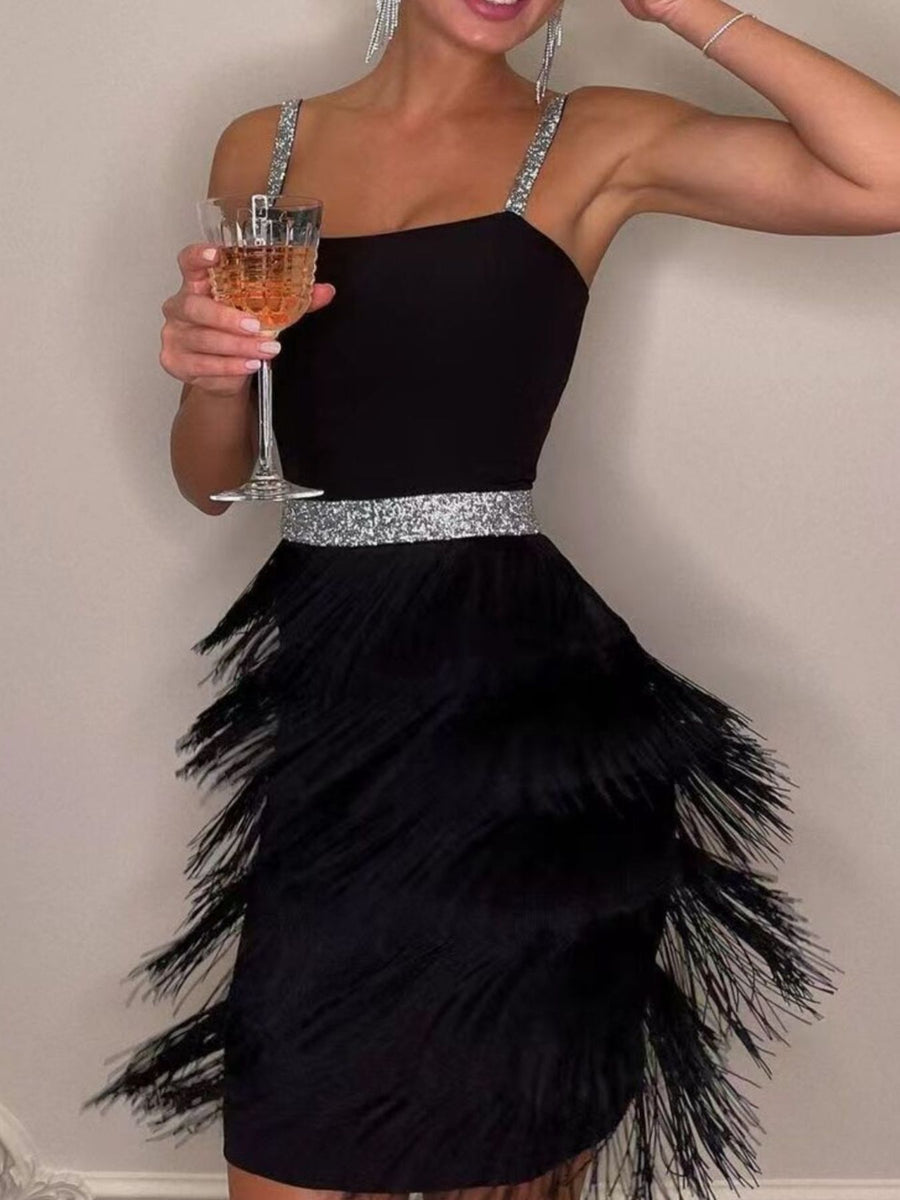 Black cami mini dress with fringe trim and sequin belt.
