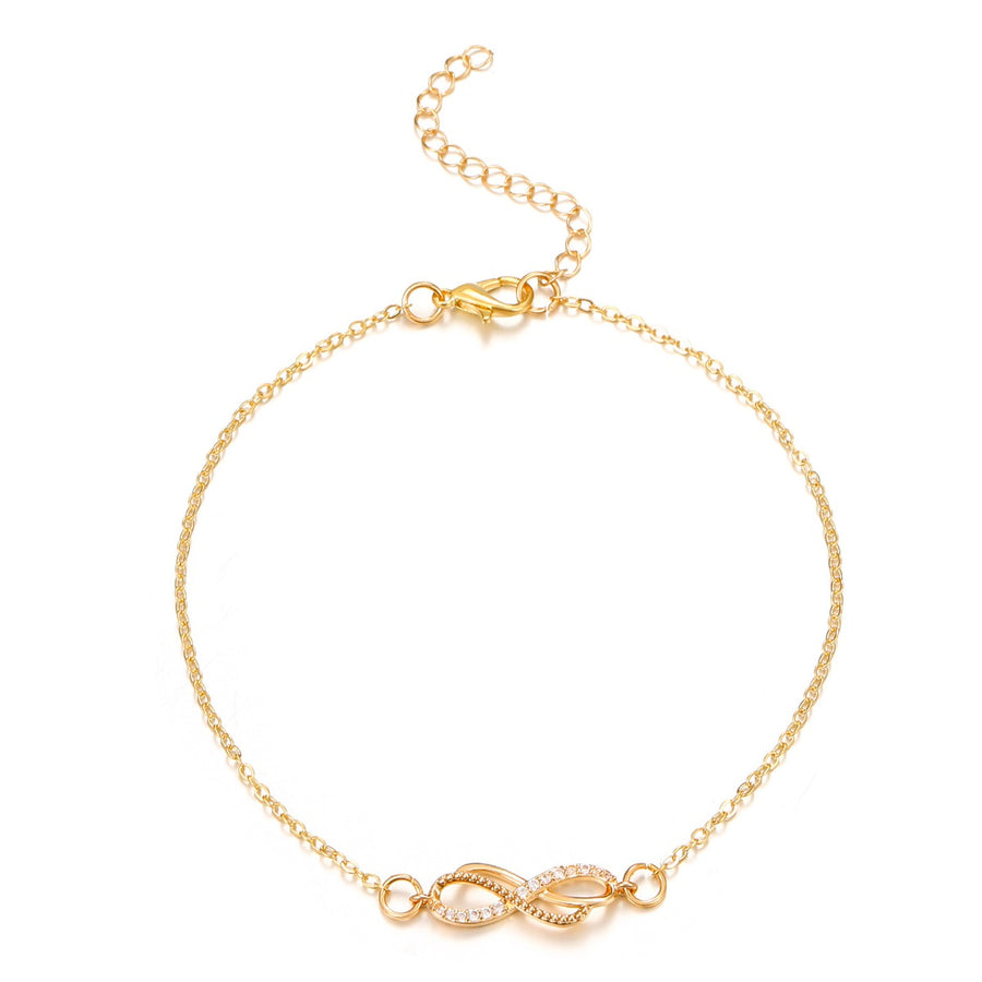 Gold infinity knot charm bracelet with delicate pave stones and adjustable chain