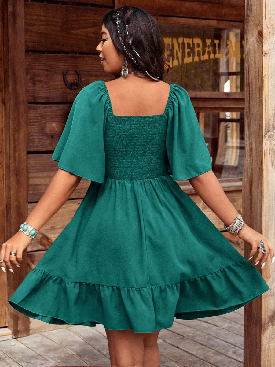 Green smocked square neck flutter sleeve dress with ruffled hem