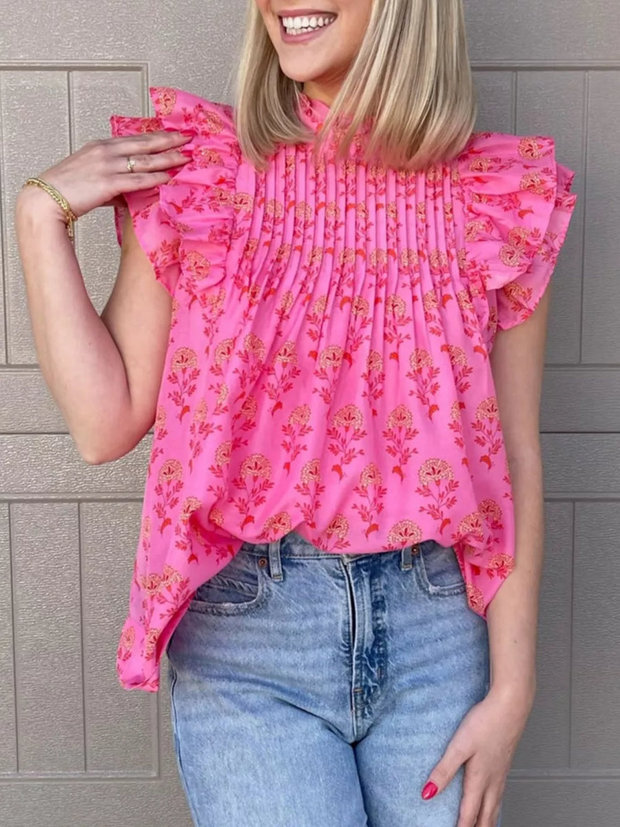 Pink floral print blouse with ruffled flutter sleeves and pleated neckline.