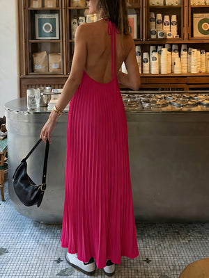 Backless pleated maxi dress in fuchsia pink with halter neck.