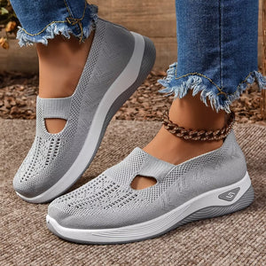 Grey breathable mesh slip-on shoes with a chunky white sole and cutout detail.