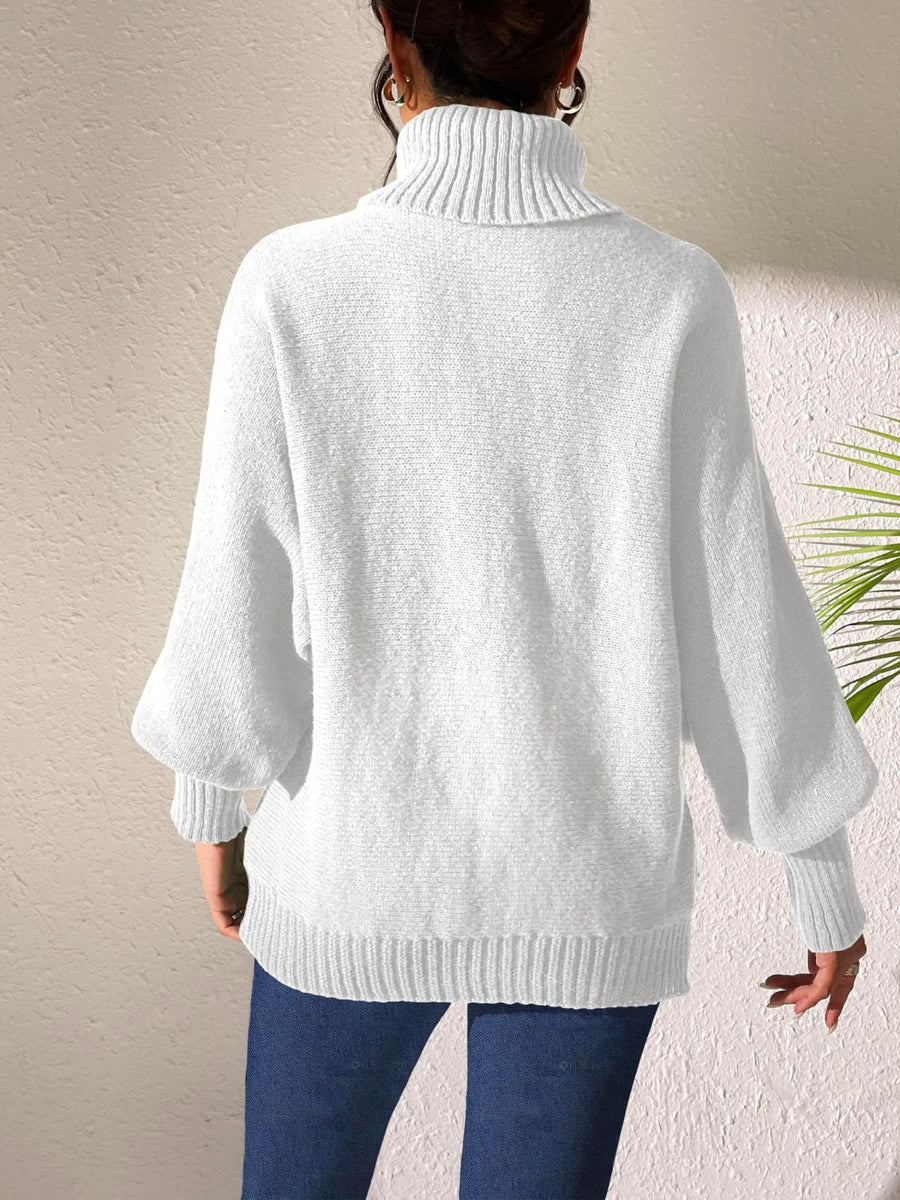 White knit turtleneck sweater with balloon sleeves and ribbed trim.