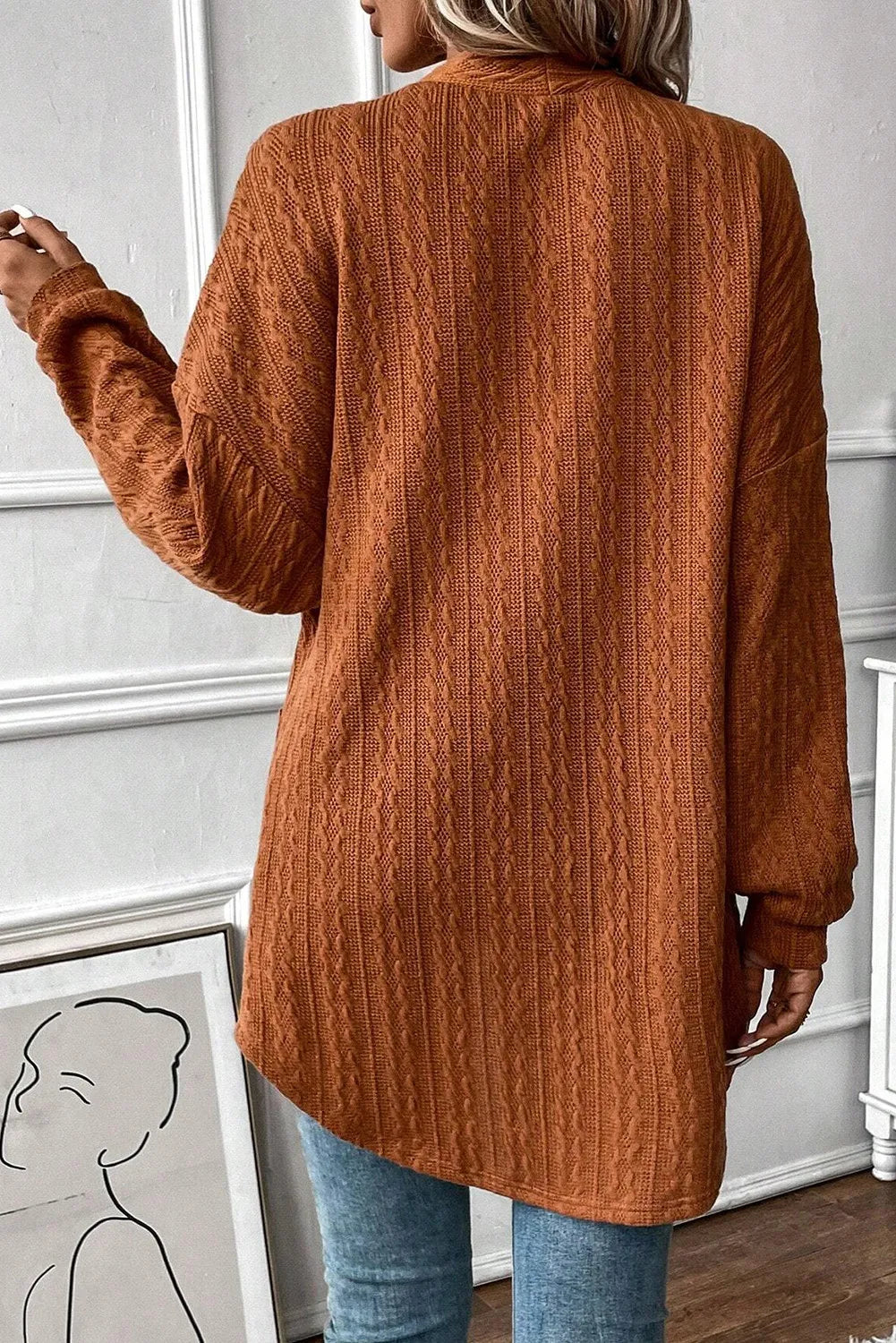 Terracotta open front cardigan with cable knit texture and long sleeves