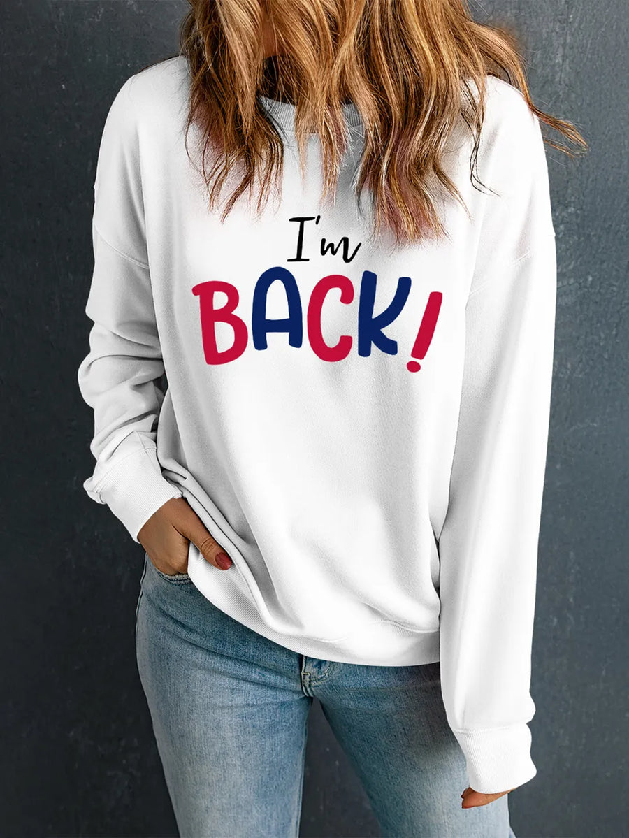 White crewneck sweatshirt with black and red "I'm BACK!" graphic print