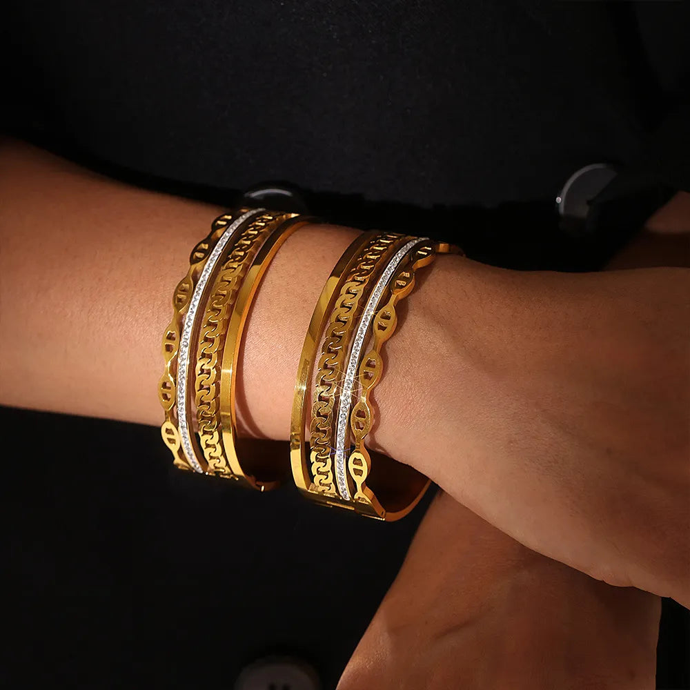 Gold cuff bracelets with chain and crystal details