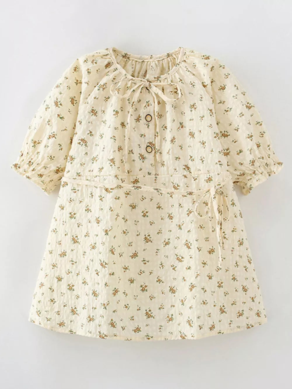 Cream floral puff sleeve toddler dress with button front and tie waist.