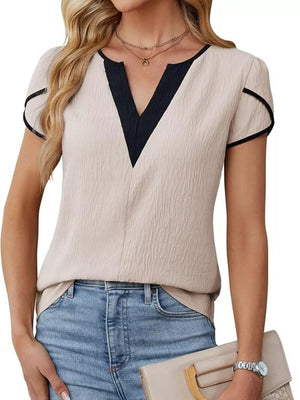 Notched V-neck blouse in beige with black trim and petal sleeves.