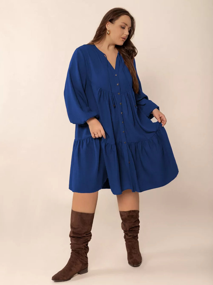 Plus-size dark blue button-front a-line dress with tie-neck and tiered skirt