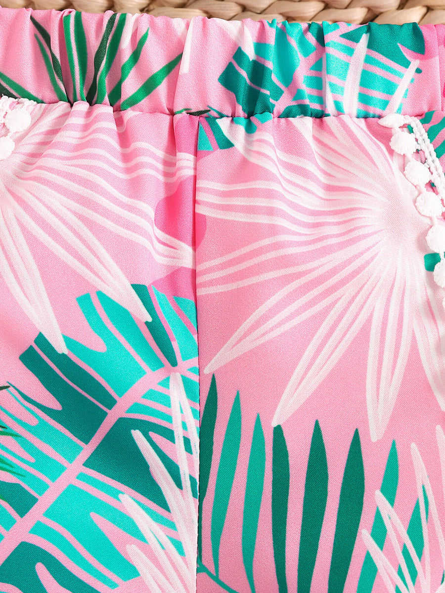 Pink floral print baby shorts with elasticated waist and pom-pom trim.
