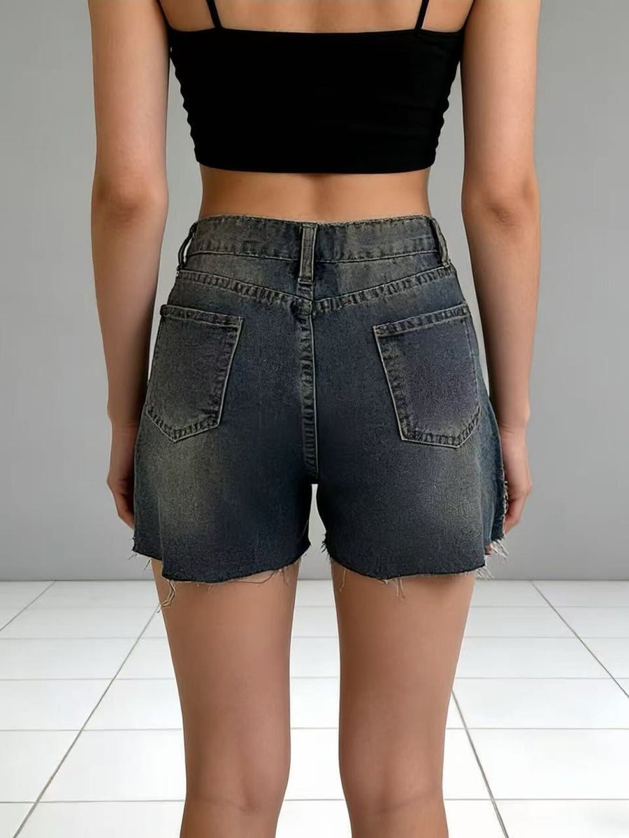 Dark wash denim shorts with frayed hem and distressed details