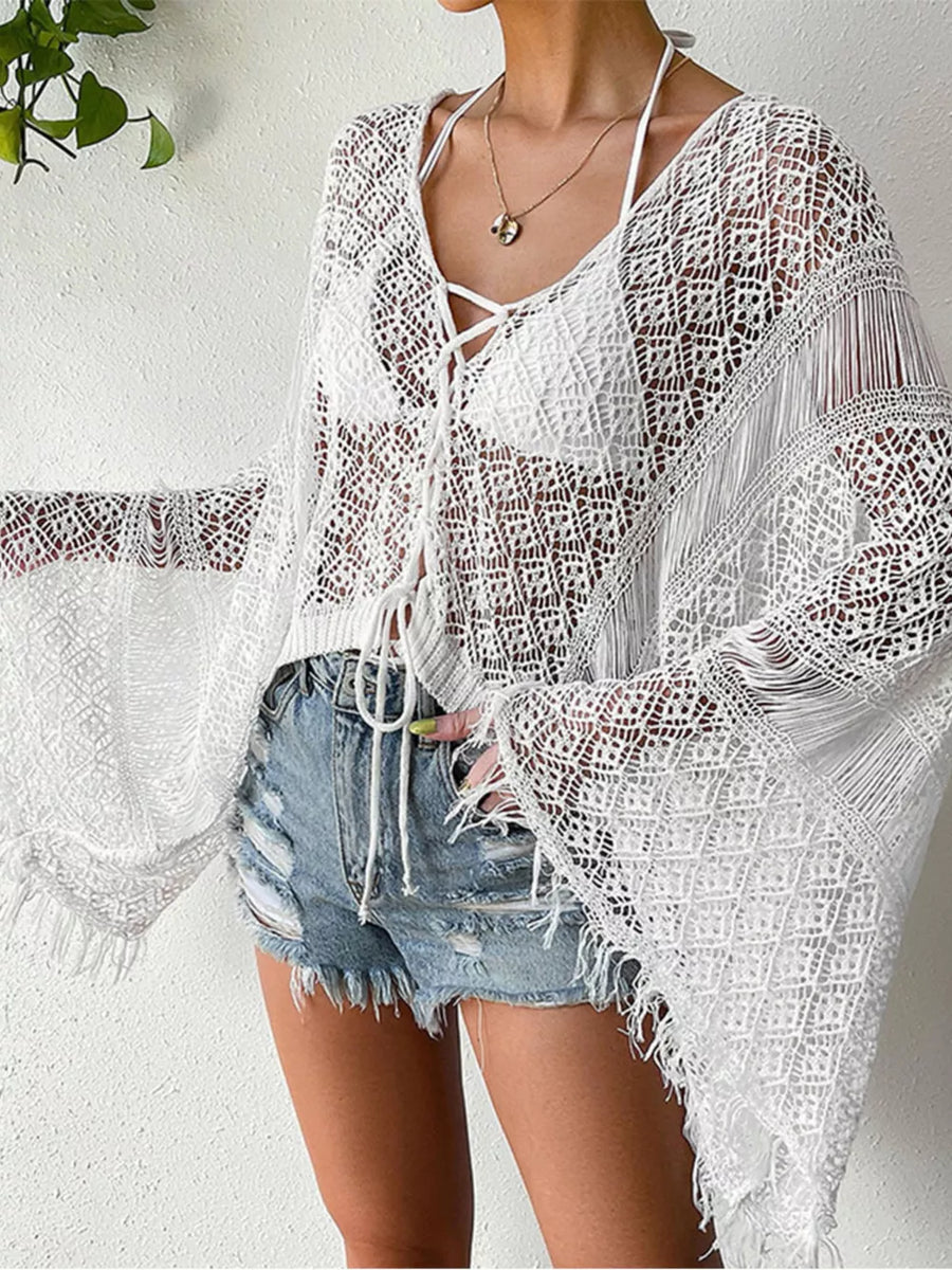 White crochet knit beach cover-up with lace-up neckline and fringe details.