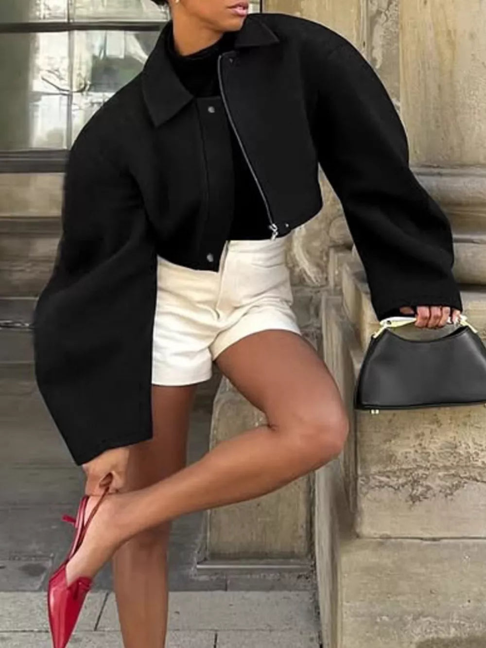jacket in black featuring collared and boxy fit