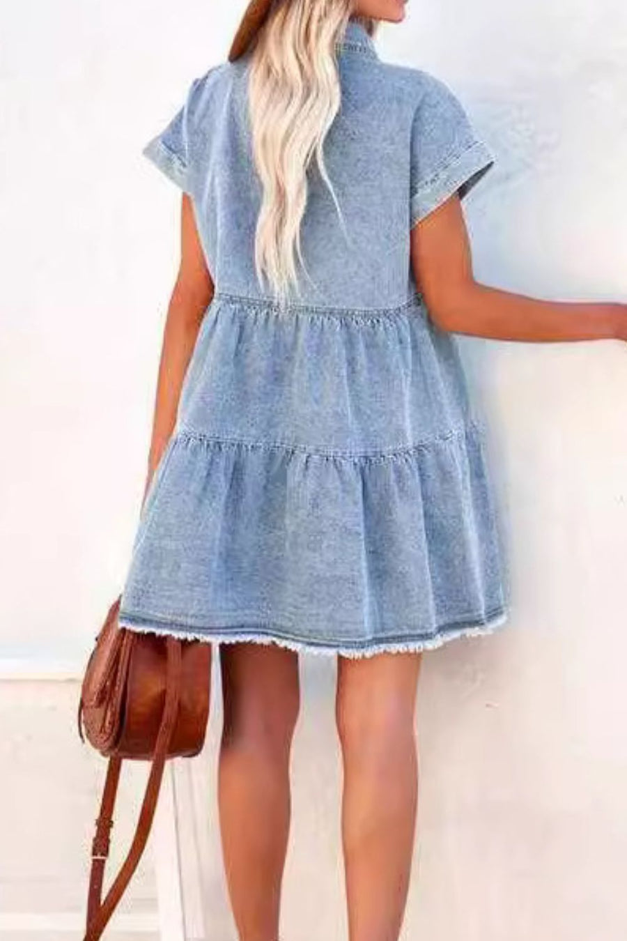 Light blue tiered denim shirtdress with frayed hem and short sleeves.