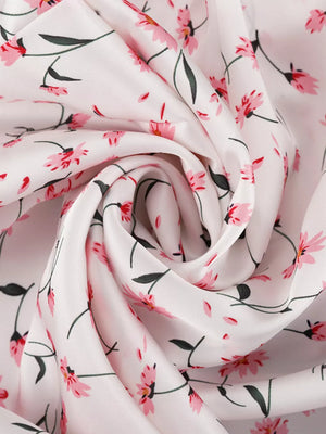 White fabric with a pink floral print and green stems