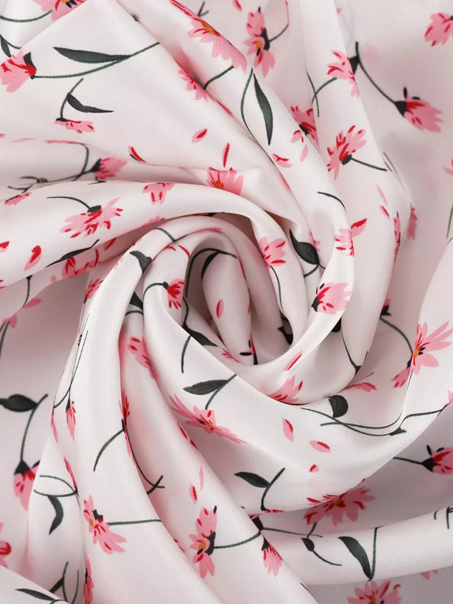 White fabric with a pink floral print and green stems