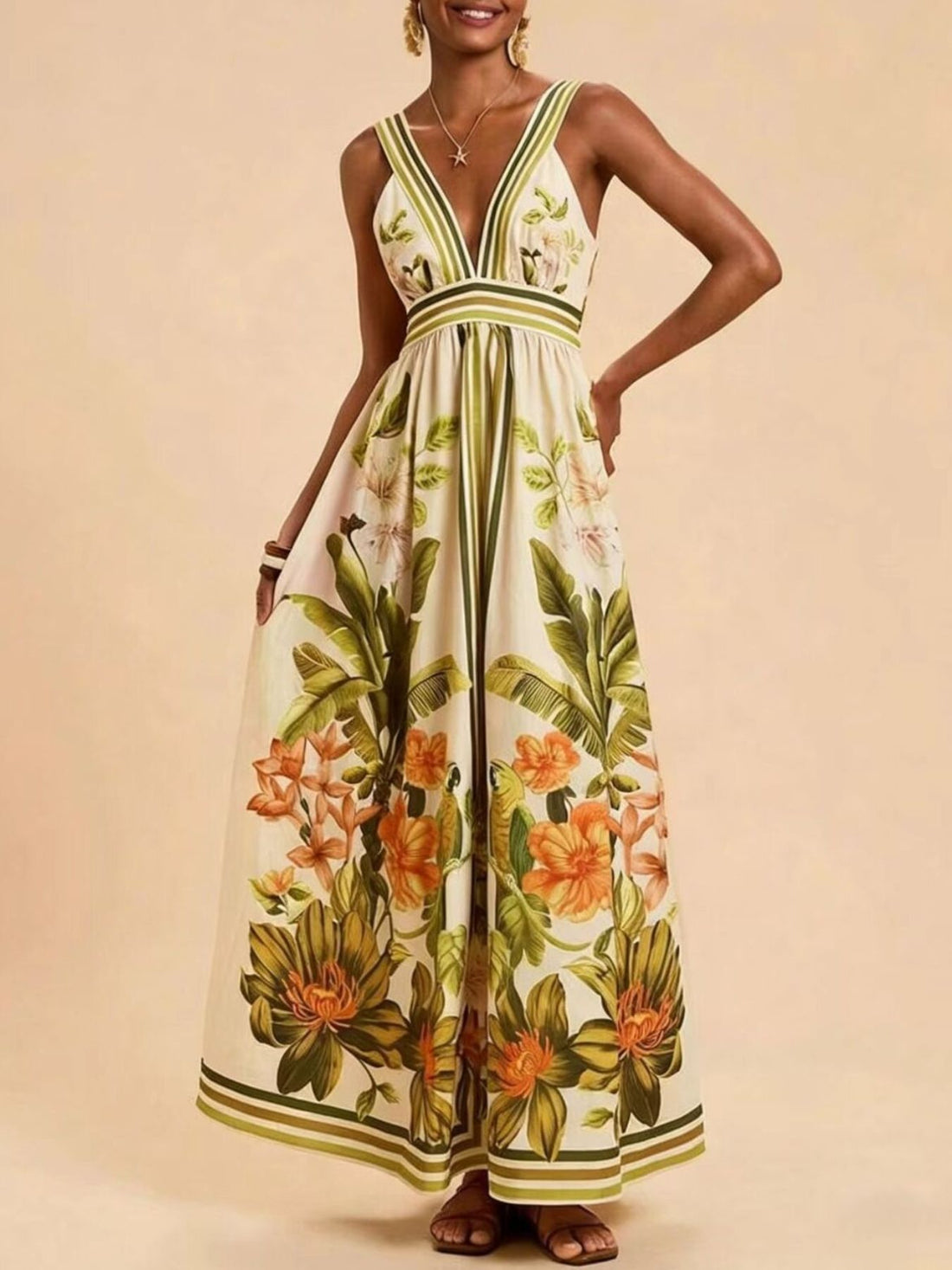 Tropical leaf print maxi dress with deep V-neck and empire waist.