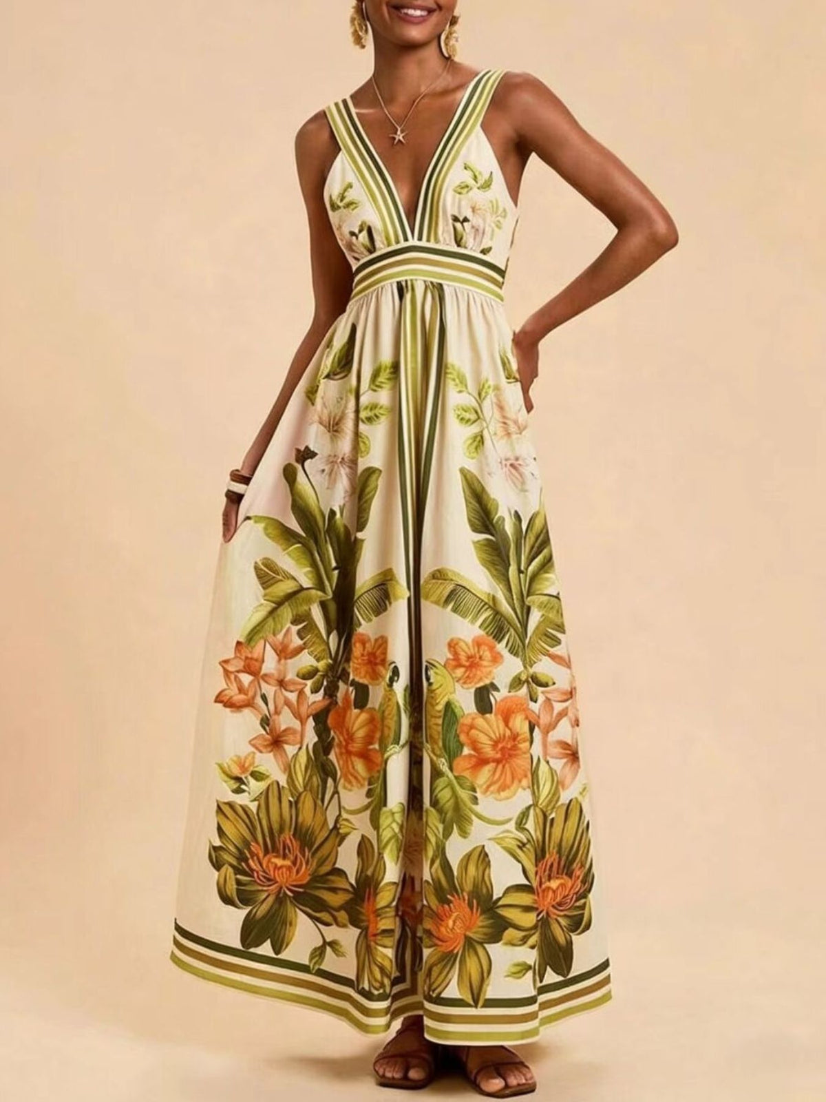 Tropical leaf print maxi dress with deep V-neck and empire waist.