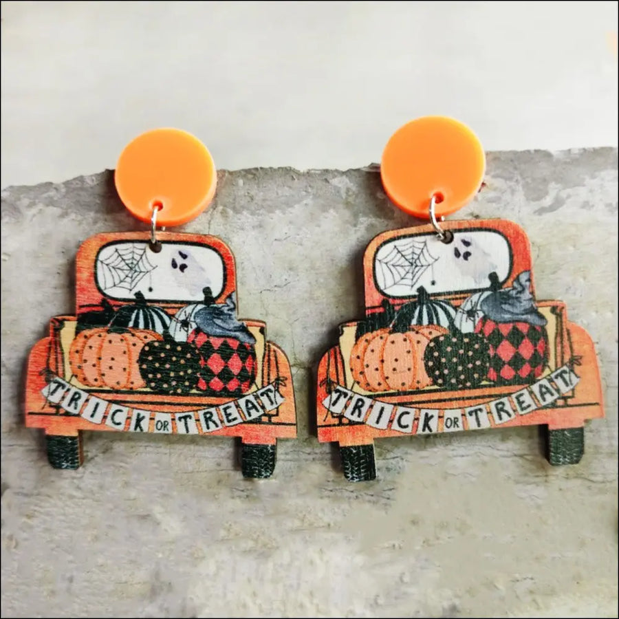 Spooky teacher statement earrings with orange trucks, pumpkins, and trick or treat banner.