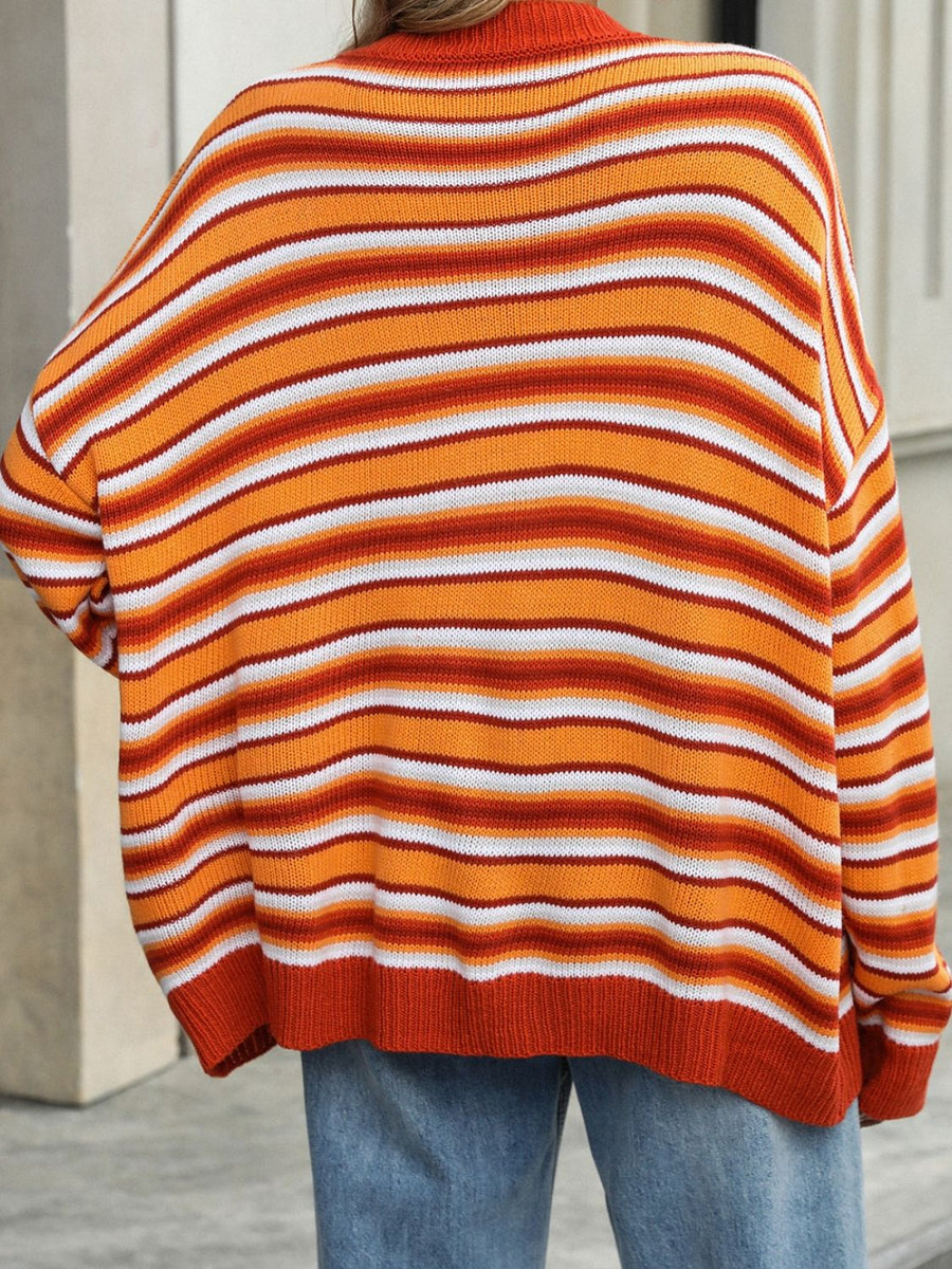 Oversized knit sweater with horizontal stripes in orange, white, and red.
