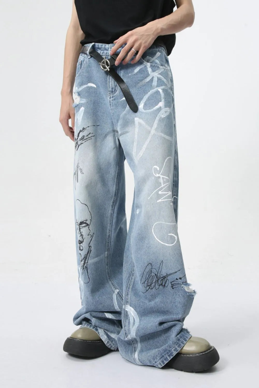 Graffiti art oversized denim trousers in medium wash with distressed details and a loose fit.