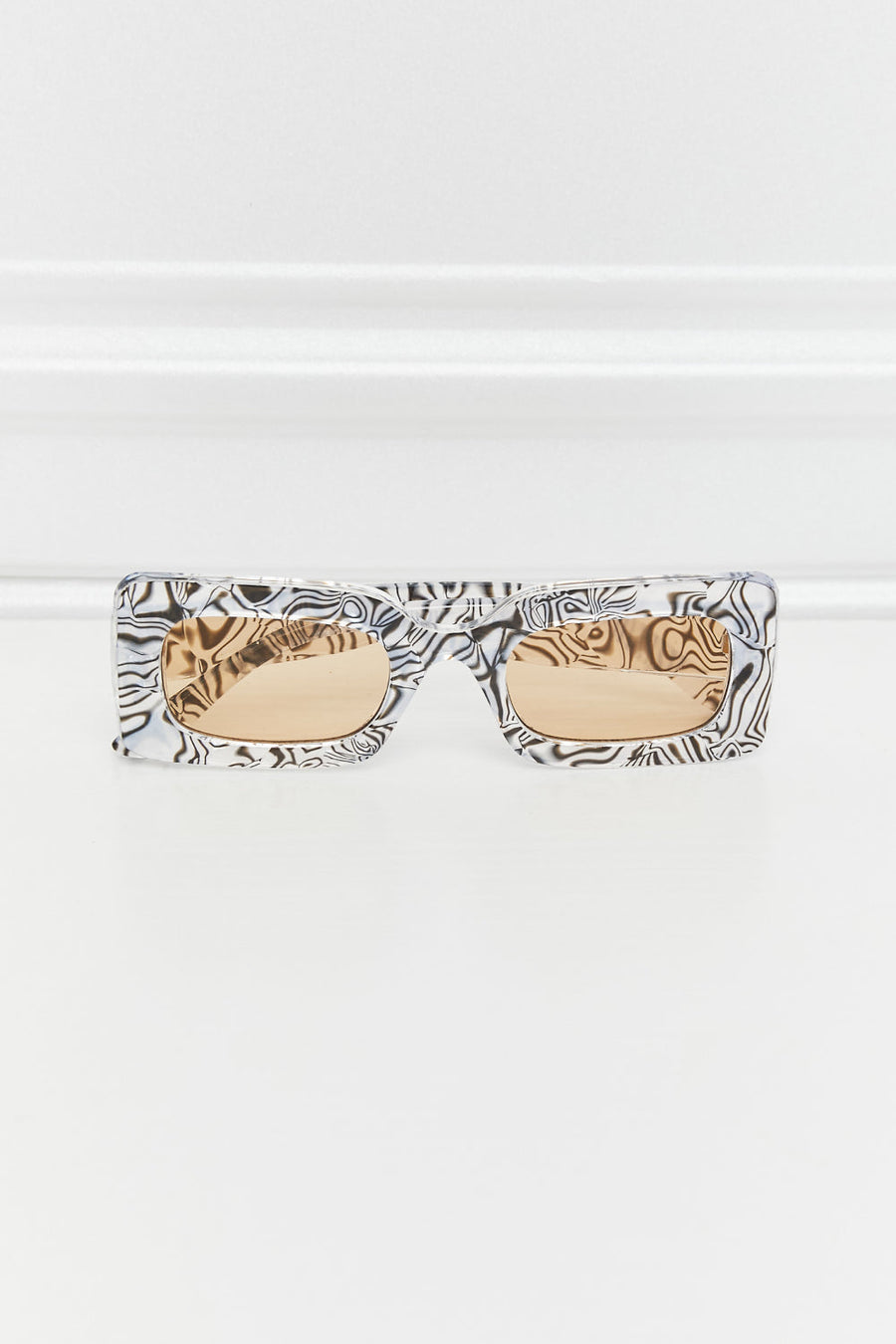 Rectangular frame sunglasses with black and white swirl print and amber lenses