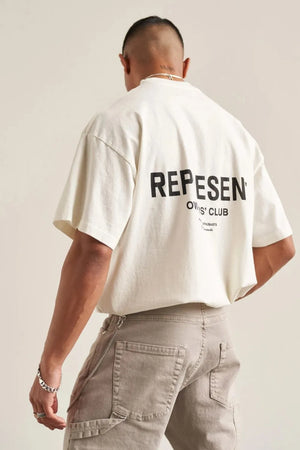 Oversized ivory graphic tee with black "REPESENT OWNERS' CLUB" text on back.