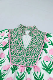 Playful floral v-neck blouse with puff sleeves, green and pink pattern, frill collar, polyester