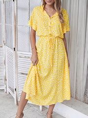 Yellow polka dot midi dress with drawstring waist and short sleeves.
