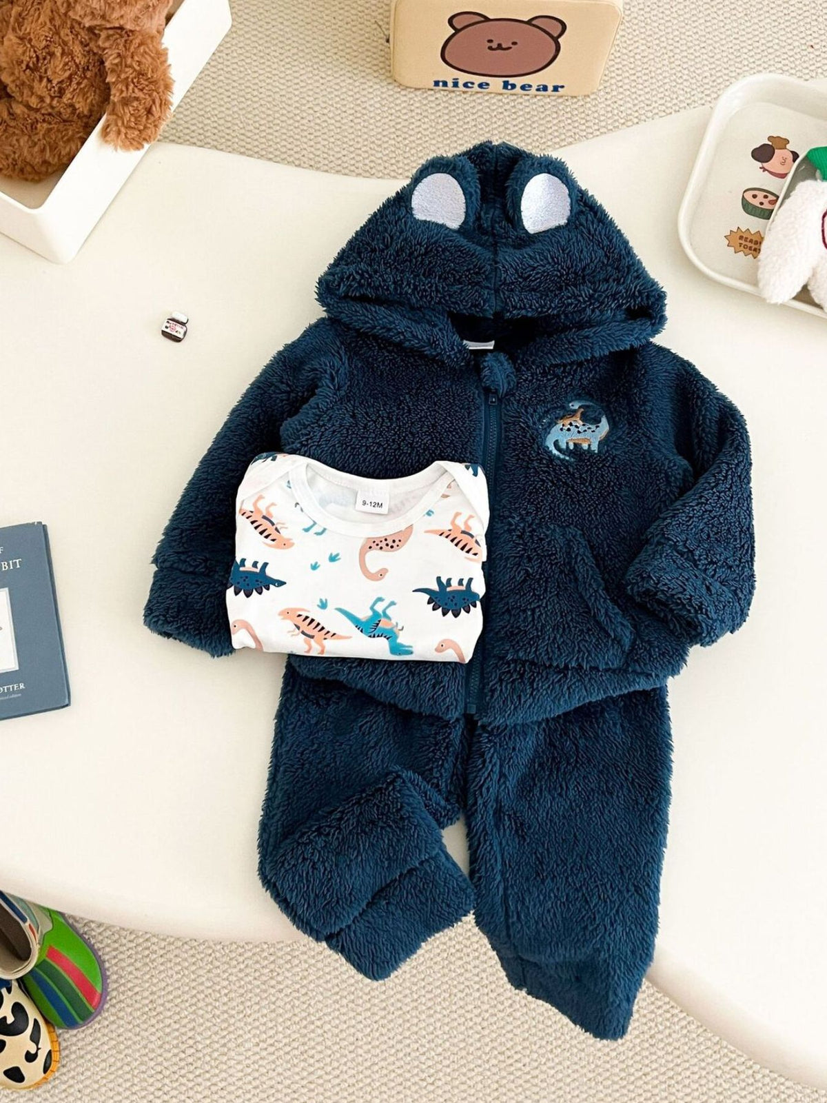 navy blue pajama set with dinosaur print and hooded