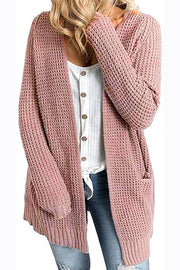 Dusty pink waffle knit longline cardigan with pockets and open front, worn over a white button-up shirt.