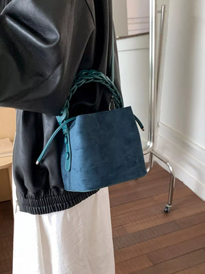 Mini chain strap crossbody bag in blue suede with braided strap detail.
