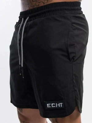 Black performance shorts with drawstring and logo patch