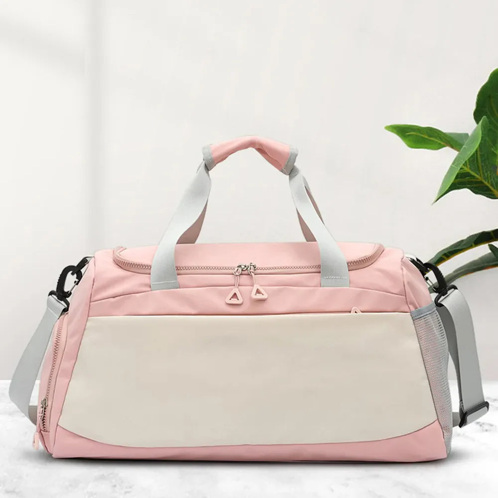 Blush pink and beige colorblock duffel bag with dual zippers and side mesh pockets.