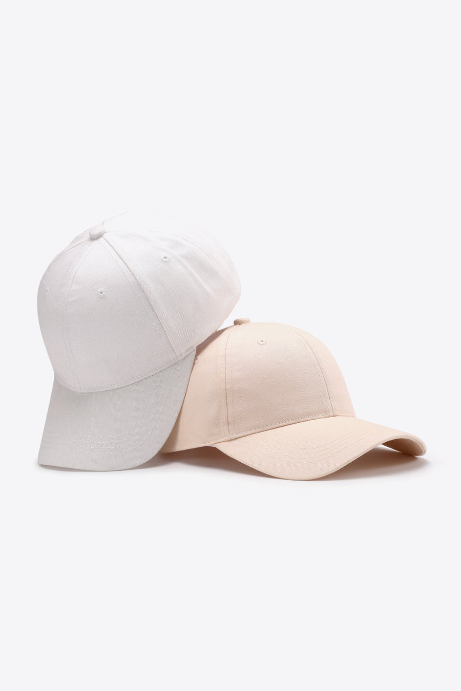 Cream and white cotton twill baseball caps stacked