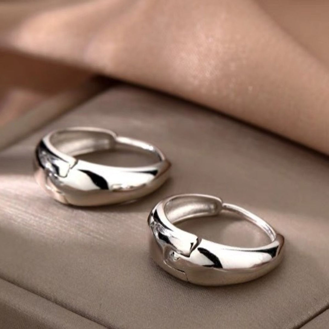 earrings in silver featuring polished finish and hoop fit