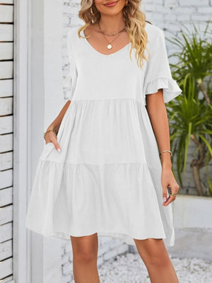 White ruffled sleeve mini dress with pockets and tiered skirt.